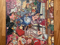 A finished Wasgij puzzle about a stolen purse in a train carriage